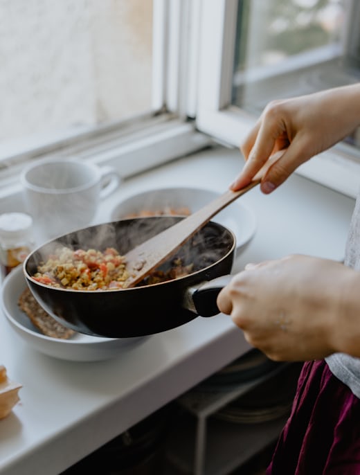 Hands chopping vegetables on a board